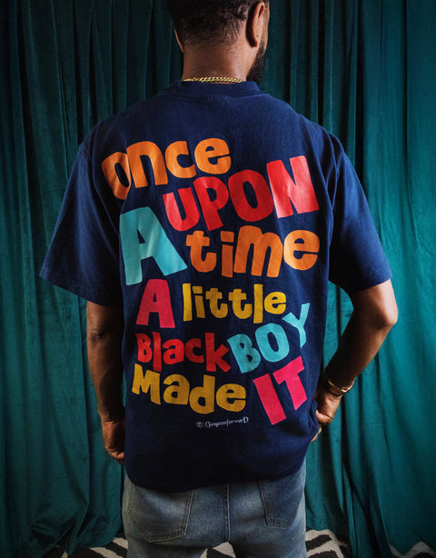 Man wearing Dungeon Forward - Once Upon - Midnight Premium Tee Shirt with colorful storytelling text on back, innovative streetwear style